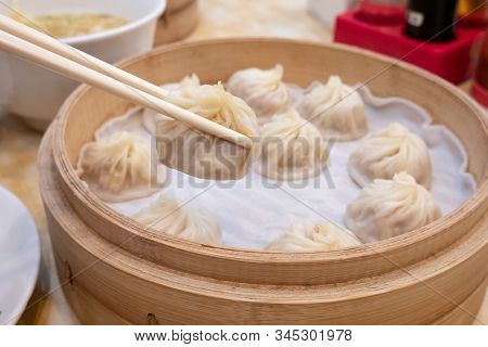 Xiao Long Bao Soup Dumpling Buns With Chopsticks In Restaurant (traditional Chinese Food) In Taipei