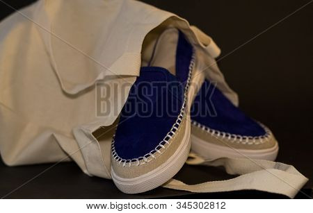 On Black Background Of The Shopping Bag, Shopper, Of Beige Cloth And Blue Slipons Of Suede. Street F