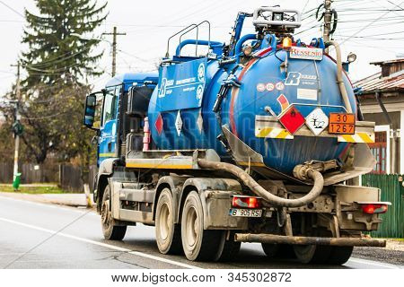 Cars On The Asphalt Road. Utility Car (from Rohrer Group Company) In Traffic.  Targoviste, Romania,