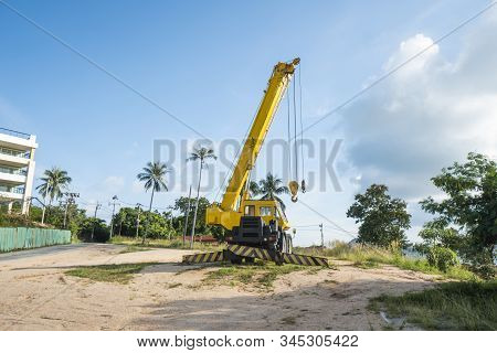 Yellow Automobile Crane With Risen Telescopic Boom Outdoors. Mobile Construction Crane On A Construc