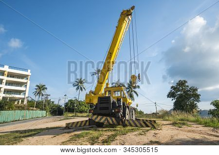 Yellow Automobile Crane With Risen Telescopic Boom Outdoors. Mobile Construction Crane On A Construc