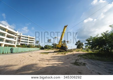 Yellow Automobile Crane With Risen Telescopic Boom Outdoors. Mobile Construction Crane On A Construc
