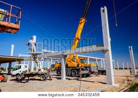 Zrenjanin, Vojvodina, Serbia - April 20, 2018: Mobile Crane Is Operating And Worker Is Assembly Conc