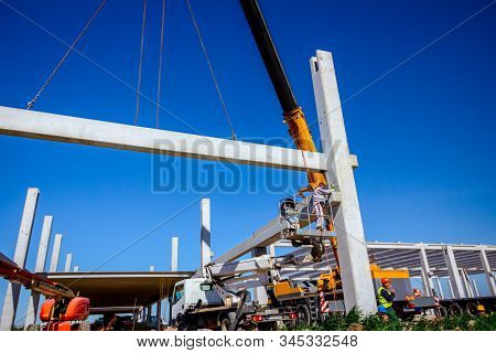 Zrenjanin, Vojvodina, Serbia - April 20, 2018:mobile Crane Is Operating And Worker Is Assembly Concr