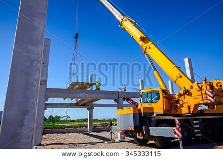 Zrenjanin, Vojvodina, Serbia - April 20, 2018: Mobile Crane Is Operating And Worker Is Assembly Conc