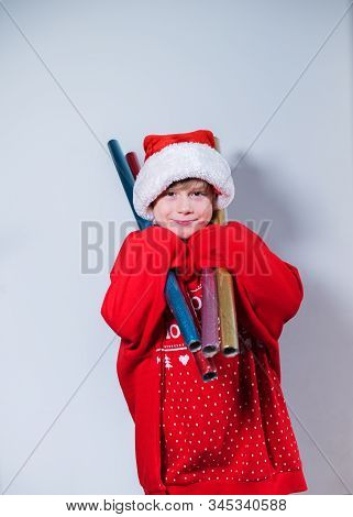 Charming Boy Wearing Santa's Hat In Red Sweater