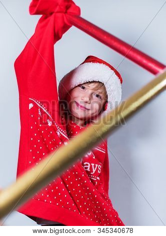 Charming Boy Wearing Santa's Hat In Red Sweater