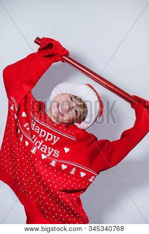 Charming Boy Wearing Santa's Hat In Red Sweater