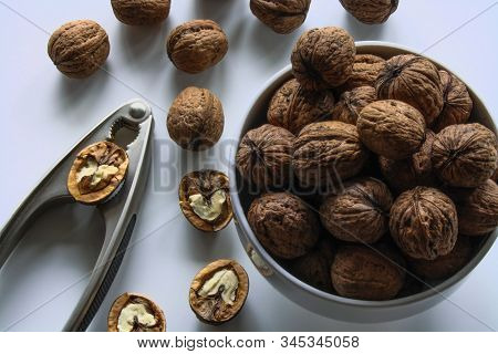 Inshell Walnuts In A White Bowl On A White Table