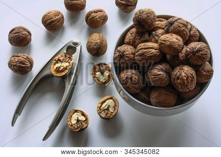 Inshell Walnuts In A White Bowl On A White Table