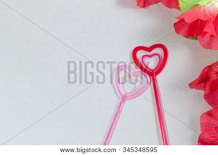 Plastic Heart Pair With Red Flowers, Brown Background