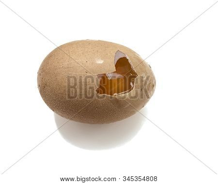 One Raw Egg Is Cracked On A White Background