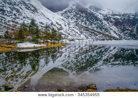Beautiful Snow-capped Mountains Reflected In A Mountain Lake Morsko Oko In The Tatra Mountains, Pola