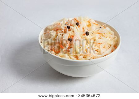 Homemade Sauerkraut. Fermented Food. Sauerkraut With Carrots In A White Bowl On A White Background C