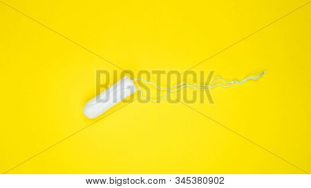 White Clean Cotton Tampon On Bright Yellow Background. Menstrual Cycle Colorful Flat Lay. Critical D