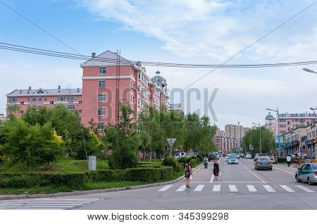 China, Heihe, July 2019: Residential Building With A Small Square With A Roadway, Streets Of The Chi