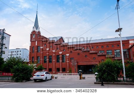 China, Heihe, July 2019: Building With A Spire, Streets Of The Chinese City Of Heihe In The Summer