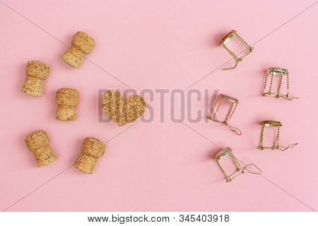 Creative Layout With Corks And Muselets From Champagne And Heart On Pink Paper With Copy Space. Back