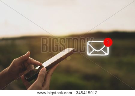 Woman Hand Use Smartphone In Public Area With 1 New Email Alert Sign Icon Pop Up. Communication Busi