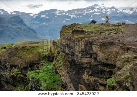 Dyrholaey, Iceland - May 21, 2019: Tourists Trekking On The Rocky Coastline Of Dyrholaey, Vik