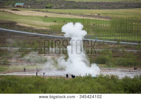 Tourists Visiting Strokkur Geyser In Iceland