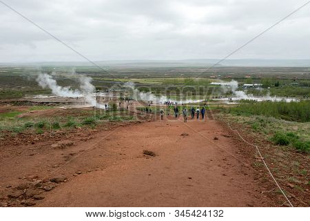 Tourists Visiting Strokkur Geyser In Iceland