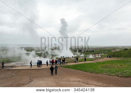 Tourists Visiting Strokkur Geyser In Iceland