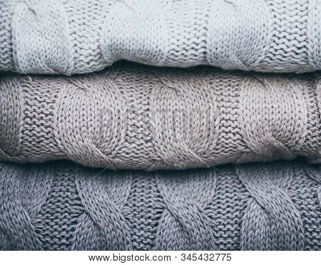Closeup On Folded Soft Knitware Sweaters, Pastel Grey Colors