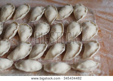 Vareniki, Dumplings With Potatoes On White Background - Traditional Ukrainian Food. Cooking Raw Dump