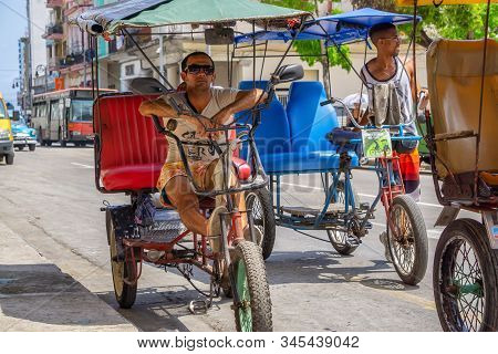 Havana, Cuba - May 16, 2019: Bicycle Taxi Driver In The Street Of Old Havana City During A Vibrant A