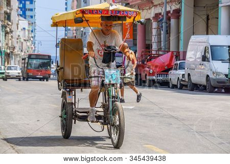 Havana, Cuba - May 16, 2019: Bicycle Taxi Driver In The Street Of Old Havana City During A Vibrant A