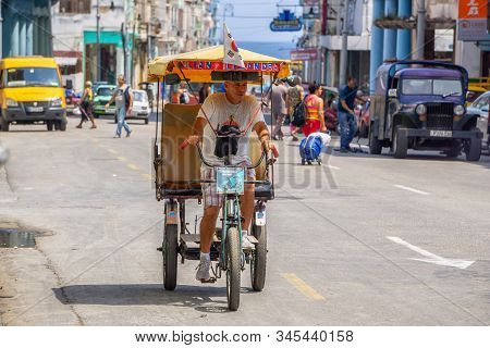 Havana, Cuba - May 16, 2019: Bicycle Taxi Driver In The Street Of Old Havana City During A Vibrant A