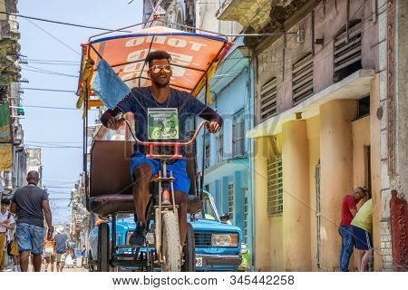 Havana, Cuba - May 16, 2019: Bicycle Taxi Driver In The Street Of Old Havana City During A Vibrant A