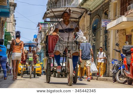 Havana, Cuba - May 16, 2019: Bicycle Taxi Driver In The Street Of Old Havana City During A Vibrant A