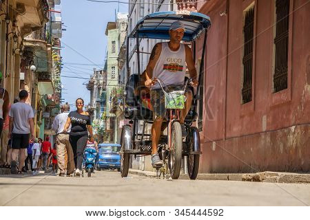 Havana, Cuba - May 16, 2019: Bicycle Taxi Driver In The Street Of Old Havana City During A Vibrant A