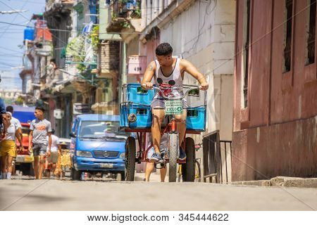 Havana, Cuba - May 16, 2019: Bicycle Taxi Driver In The Street Of Old Havana City During A Vibrant A