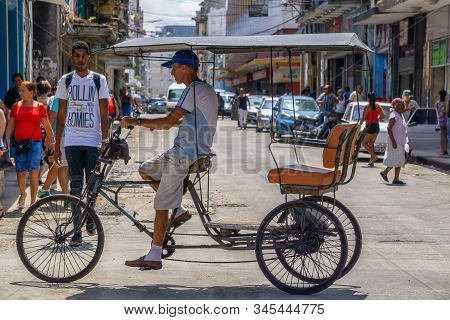 Havana, Cuba - May 16, 2019: Bicycle Taxi Driver In The Street Of Old Havana City During A Vibrant A