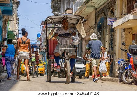 Havana, Cuba - May 16, 2019: Bicycle Taxi Driver In The Street Of Old Havana City During A Vibrant A