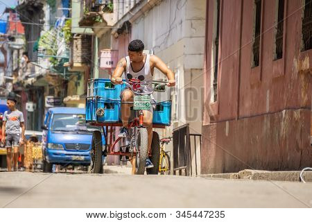 Havana, Cuba - May 16, 2019: Bicycle Taxi Driver In The Street Of Old Havana City During A Vibrant A