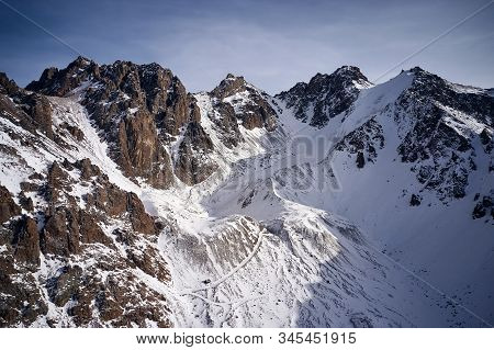 Snow Rocky Mountains With Blue Sky In Kazakhstan