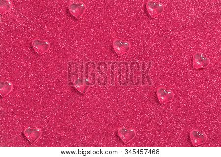 Crystal Drops Of Glassy Hearts On Shiny Glitter Background