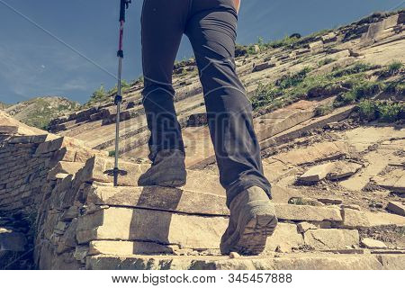Low Angle View Of Hikin Boots Ascending Steps.