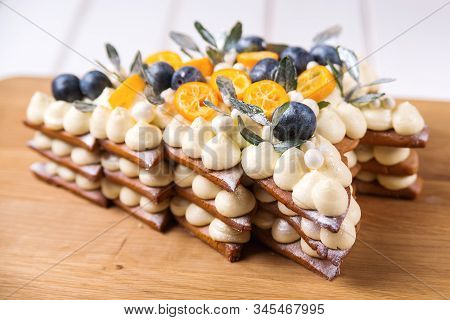 Delicious Christmas Pie Decorated With Berry And Kumquat On Wooden Board. Sweet Holiday Background.
