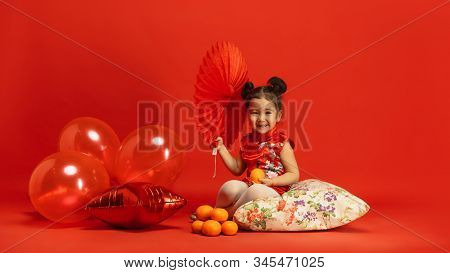 Balloons And Mandarines For Mood. Happy Chinese New Year 2020. Asian Cute Little Girl On Red Backgro