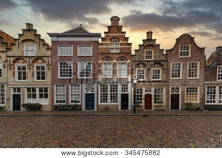 Amsterdam City House With The Typical Flemish Architectural Style Laying In Line Under A Tiny Rain W