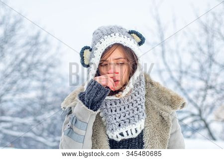 Cold Flu Winter Season, Runny Nose. Showing Sick Woman Sneezing At Winter Park