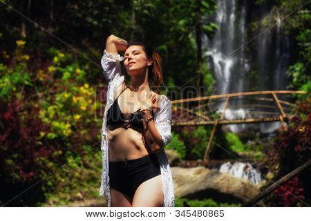 Woman near Labuhan Kebo Waterfall located in Munduk, Bali
