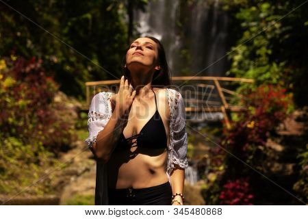 Woman near Labuhan Kebo Waterfall located in Munduk, Bali