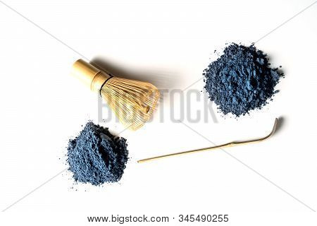 Heaps Of Matcha Blue Tea Powder And Bamboo Chasen Isolated On White Background, View From Above.