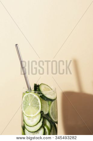 Glass Of Tonic Water With Cucumber And Lime And Metal Straw On Yellow Background. Summer Cocktail Cl